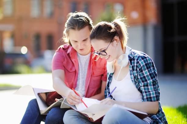 istock Young happy students with books and notes outdoors 927589534