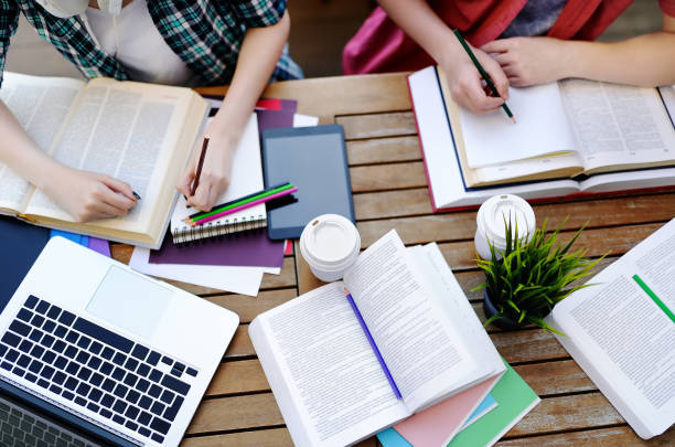 istock Top view of young students with books and notes in cafe 927591004