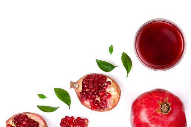 istock pomegranate juice with fresh pomegranate fruits isolated on white background with copy space for your text. Top view 927591808