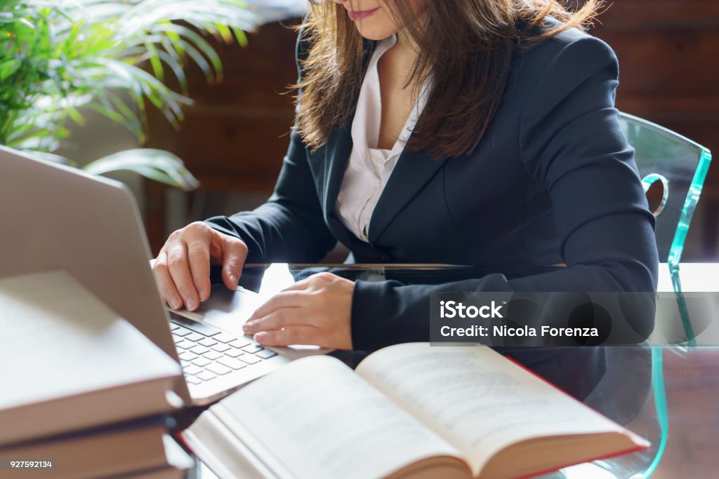 Business woman working on a laptop. Business, legal law, advice and justice concept. Selective focus. Lawyer Stock Photo