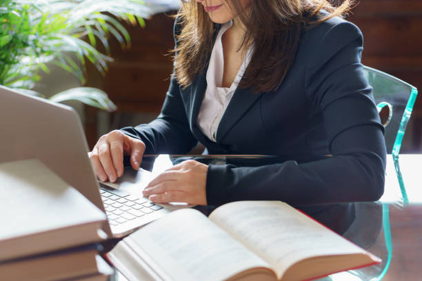 Business woman working on a laptop. Business, legal law, advice and justice concept. Selective focus. Business woman working on a laptop. Business, legal law, advice and justice concept. Selective focus. legislator photos stock pictures, royalty-free photos & images