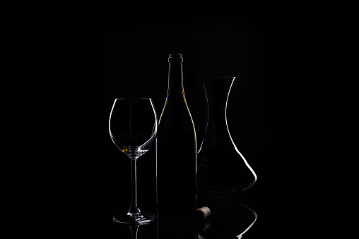 Dishes for drinking and decanting wine at black background
