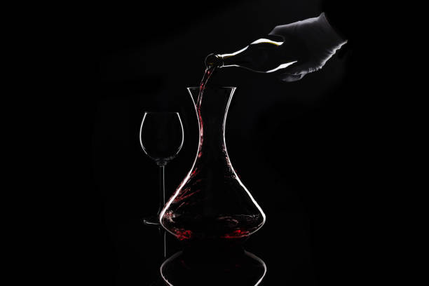 escanção derramar vinho tinto da garrafa para o decantador - wine decanter elegance pouring - fotografias e filmes do acervo