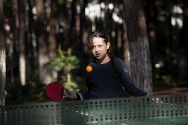istock girl playing table tennis 927599562