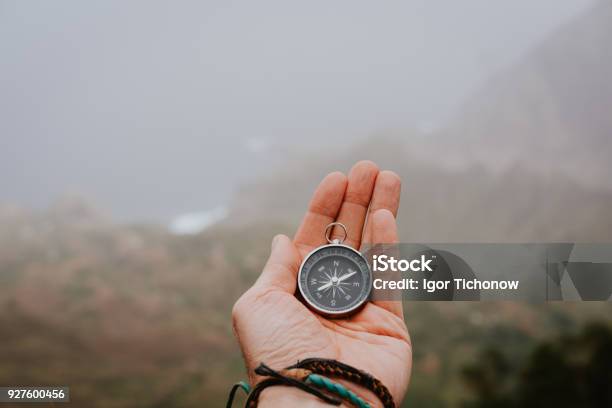 Looking At The Compass To Figure Out Right Direction Foggy Valley And Mountains In Background Santo Antao Cape Cabo Verde Stock Photo - Download Image Now