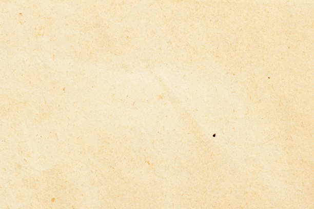 istock Texture of ecological beige paper, background for design with copy space text or image. Recyclable material, has small inclusions of cellulose 927600808