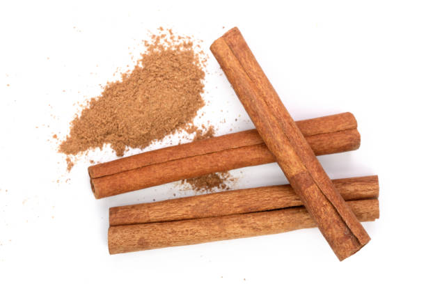 istock Cinnamon sticks with powder isolated on white background. Top view 927604428