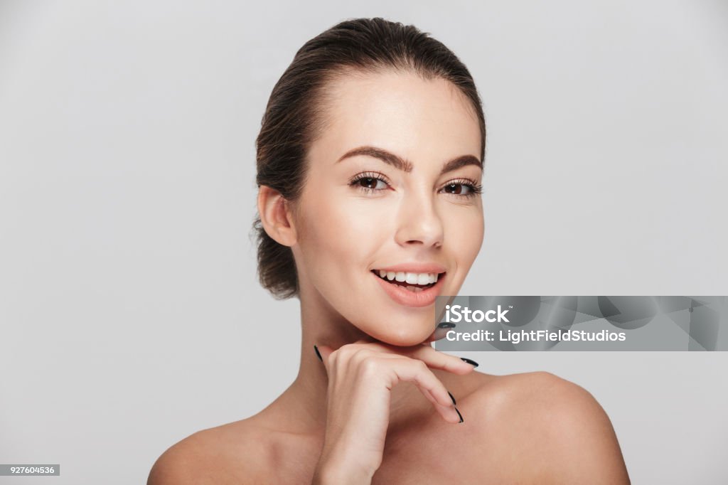 attractive smiling young woman with perfect skin isolated on white Human Face Stock Photo