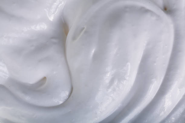 istock close up of a white whipped or sour cream on white background 927604880