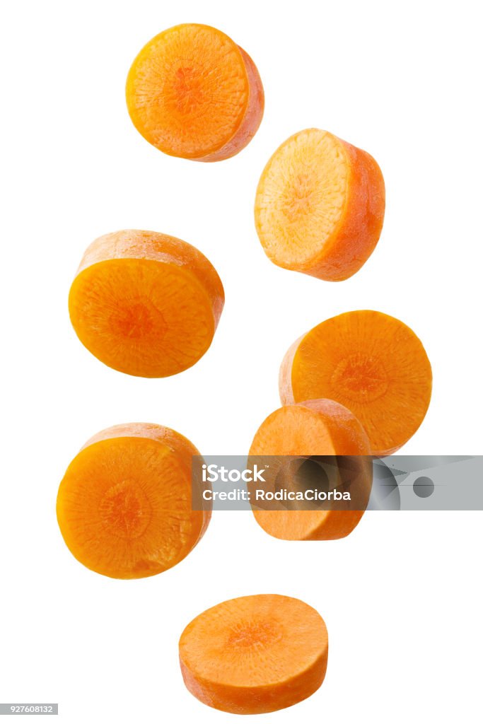 Falling sliced carrot isolated on white background Isolated falling vegetables. Falling sliced carrot isolated on white background with clipping path as package design element. Carrot Stock Photo