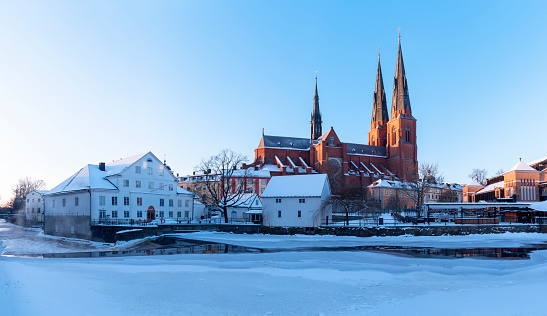 View to the Uppsala Cathedral along the river Fyris during winter under snowy conditions