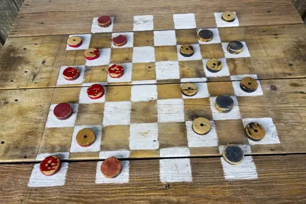 Photo of Vintage Checkers Table With Wood Red and Black Game Pieces