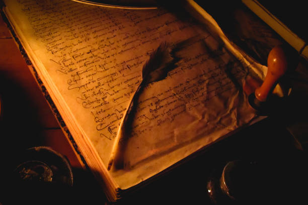 istock Medieval book with a feather pen in a medieval fair. 927616486