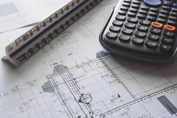 Photo of Detail view of architectural and structural construction drawings with designer tools.