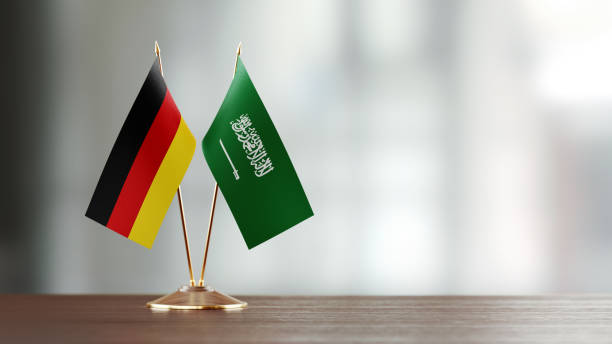 istock German And Saudi Arabian Flag Pair On A Desk Over Defocused Background 927620330