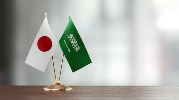 istock Japanese And Saudi Arabian Flag Pair On A Desk Over Defocused Background 927620564