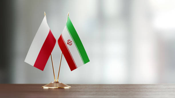istock Polish And Iranian Flag Pair On A Desk Over Defocused Background 927622972