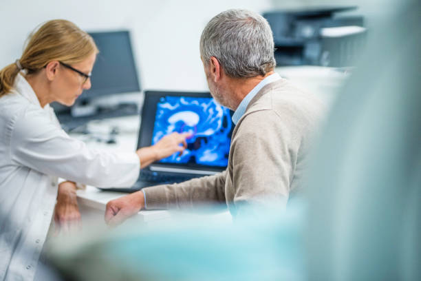 istock Doctor showing patient his brain tumour 927623298