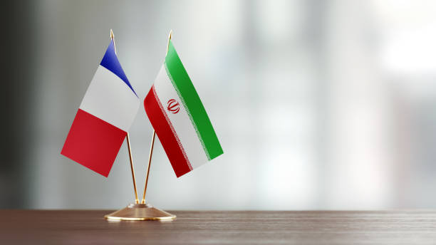 istock French And Iranian Flag Pair On A Desk Over Defocused Background 927626018