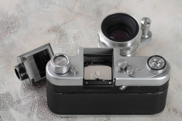 istock The old 35 mm SLR film camera on cement background. 927627138