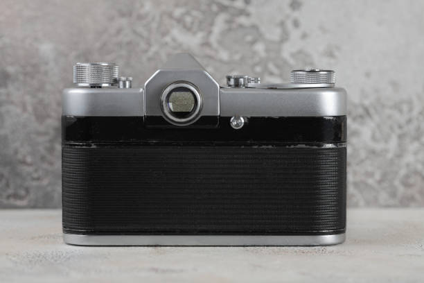 istock The old 35 mm SLR film camera on cement background. 927627140
