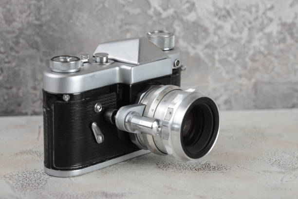 istock The old 35 mm SLR film camera on cement background. 927627146