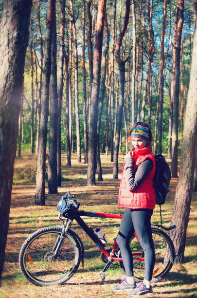 istock girl with a bicycle among the trees 927641066