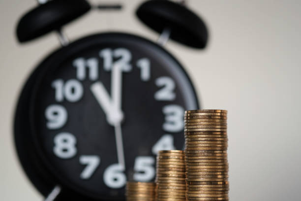 istock Step of coins stacks and alarm clock with tablet computer and financial graph, business planning vision and finance analysis concept. 927641412