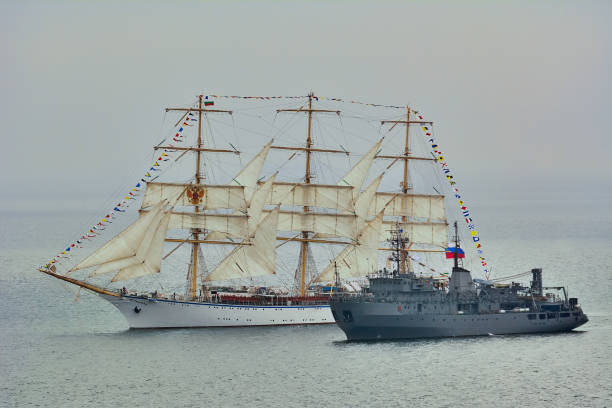 istock Degaussing ship next to the Sailing one 927646508