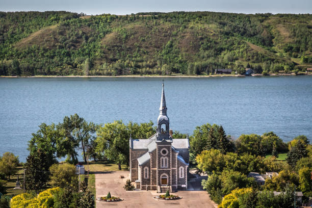 quaint stone church sitting next to a blue lake