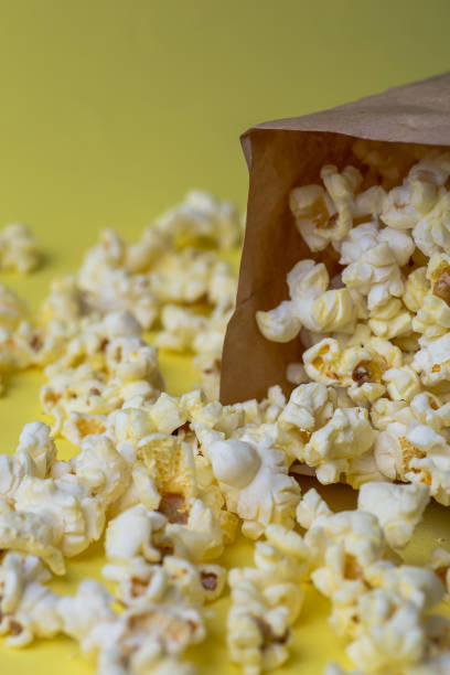 istock Popcorn in paper bag on yellow table 927647228