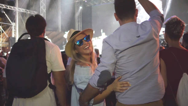 istock People dancing on summer music festival 927647562