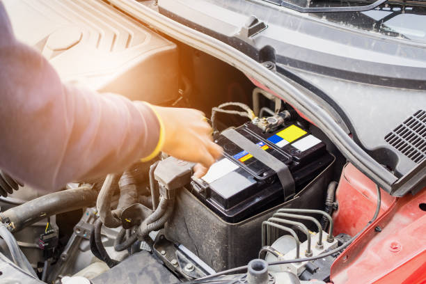 istock car mechanic use voltmeter to check car battery voltage level 927650274