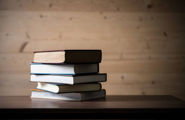 istock Stack of books on wooden table. Education concept. 927652632