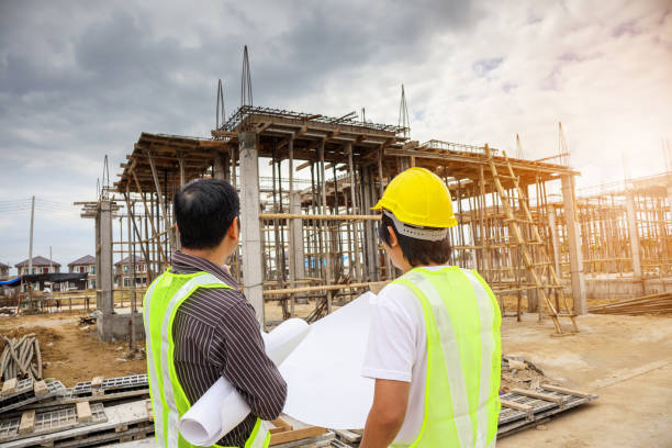 istock Asian business man construction engineer workers at house building site 927652924