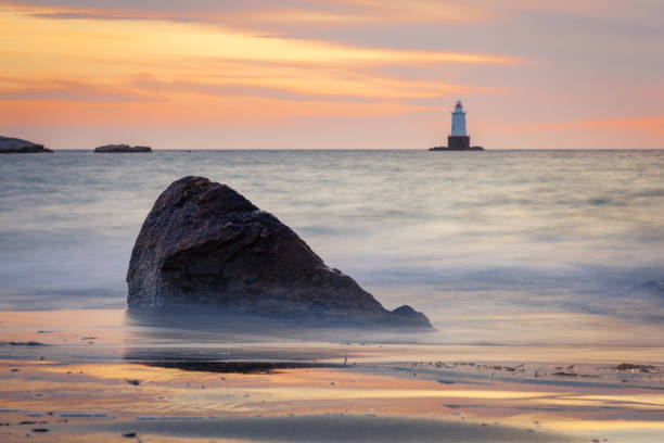 istock Silky Water Rocky Sunset Seascape with Lighthouse 927662362