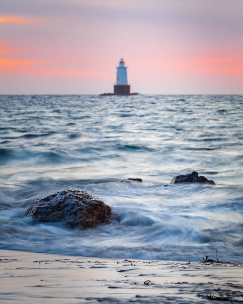 istock Silky Water Rocky Sunset Seascape with Lighthouse 927662388