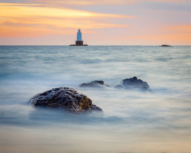 Silky Water Rocky Sunset Seascape with Lighthouse