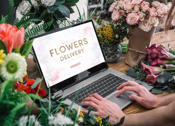 woman using interface of flower shop - flower computer young women selling imagens e fotografias de stock