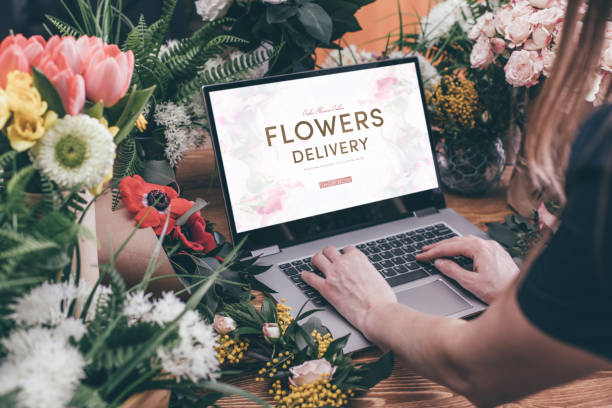 woman using interface of flower shop - flower computer young women selling imagens e fotografias de stock