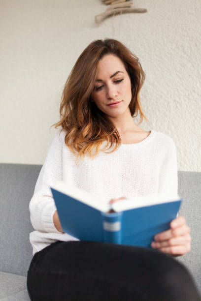 istock pretty women reading a book during her break 927670206