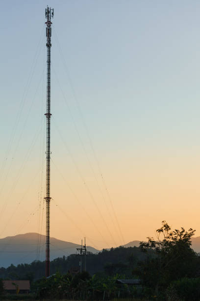 Telecommunication tower in countryside with sunset scene.