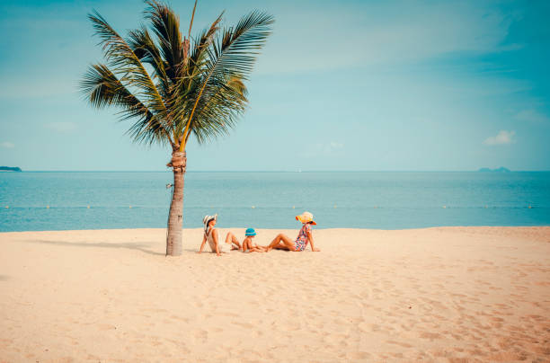 istock Woman with baby on the beach 927678382