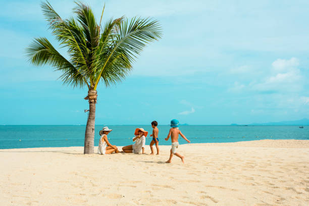 istock Woman with baby on the beach 927678406