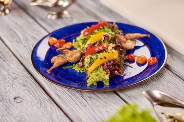 istock Warm salad with quail and nut sauce. 927684548