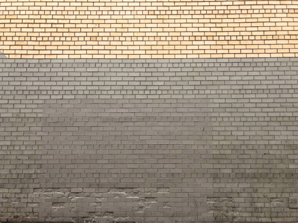 istock Yellow and gray painted brick wall 927688382