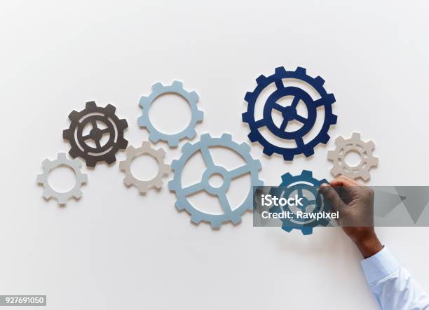 Hand With Support Gears Isolated On White Background Stock Photo - Download Image Now