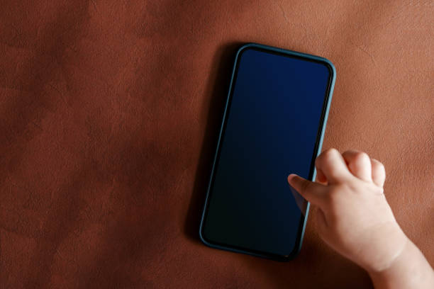 istock Smart Phone Mockup for Kids. Mobile Screen as Clipping Path. Top view. a Child touching Display 927691246