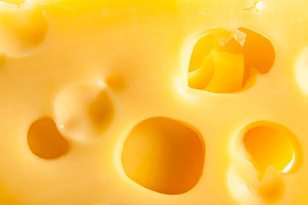 Photo of yellow cheese with holes stock photo