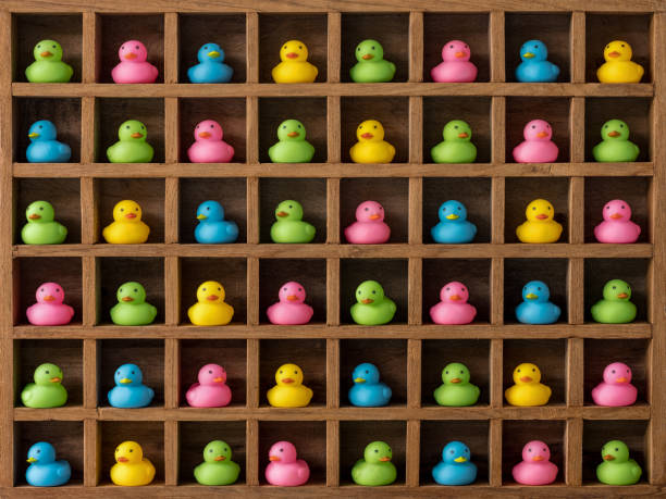 istock Many multi-colored rubber generic rubber ducks in pigeon hole compartments. 927702918